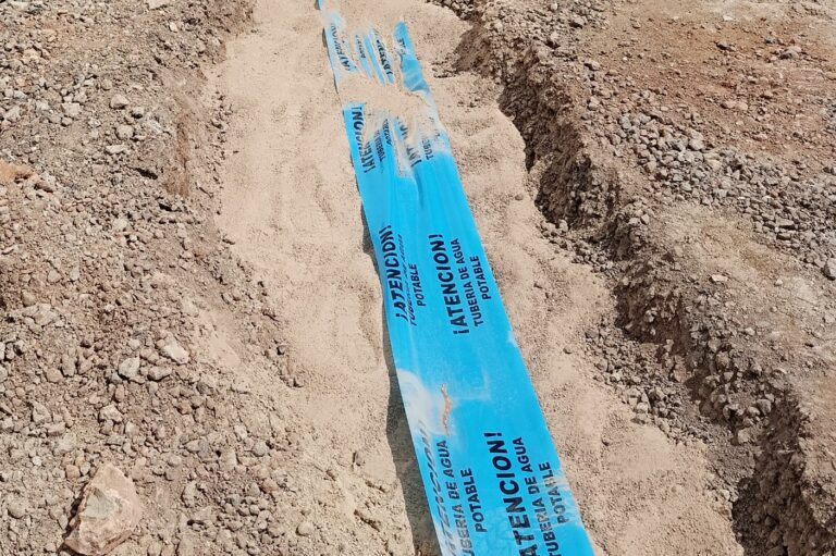 Trench with warning tape for water supply