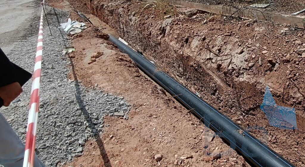 HDPE pipe for hydrant network in trench before being covered with sand bedding.