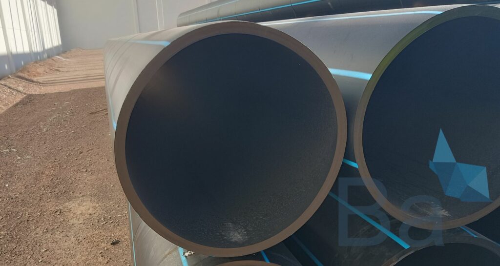 High-density polyethylene pipes stacked on-site.